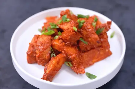 Serving hot Goan Chilli Potato garnished with coriander