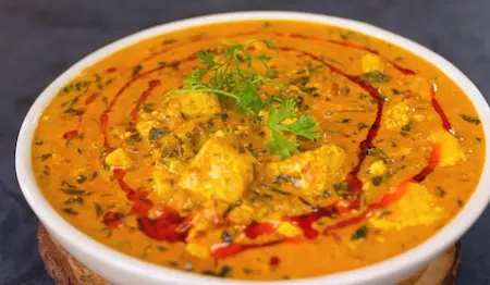 Creamy Methi Chaman with paneer cubes served hot with final garnish