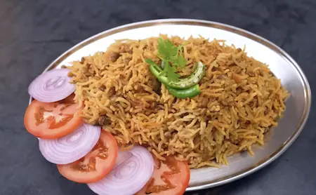 Fluffy Masoor Dal Pulao garnished with fresh coriander and mint ready to be served hot