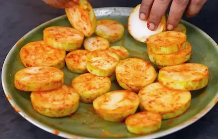 Thick bottle gourd slices marinated with spices and lemon juice for Chatpata Lauki Masala.