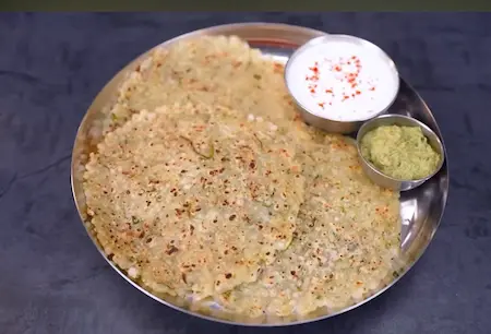 Served sabudana thalipeeth with thecha and curd on a plate