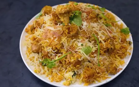 Serving Mushroom Biryani hot with mint and fried onions on top