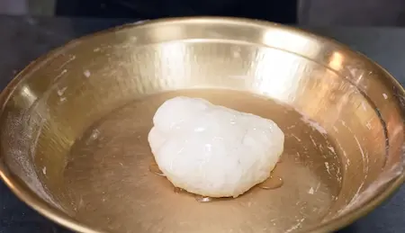 Kneading refined flour into soft dough with oil for Malabari Parotta