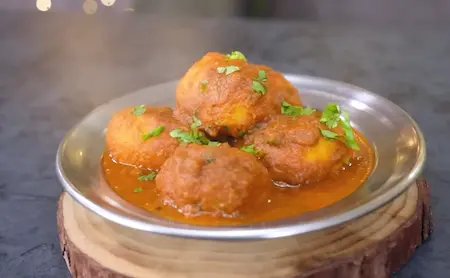 Finishing Punjabi Dum Aloo with kasoori methi for aroma