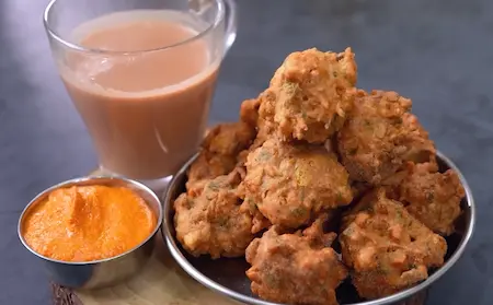 Crispy Corn Pakoda served hot with peanut chutney and tea on a rainy day