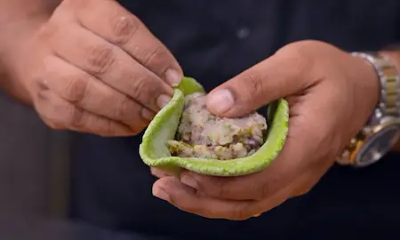 Assembling aloo methi parathas with stuffing