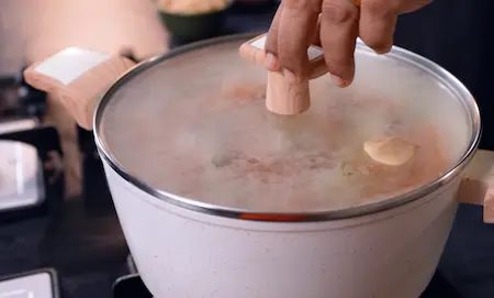 Cooking the biryani under dum to infuse all flavors.