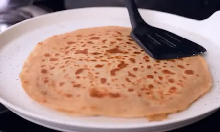Step 5: Roasting cheese burst paratha on hot tawa with butter