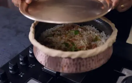Sealed lagan on dum over a tawa for cooking Mushroom Biryani