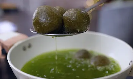 Deep frying spinach and paneer koftas for sabzi