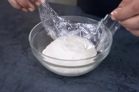 Resting the parotta dough covered to soften and develop gluten structure