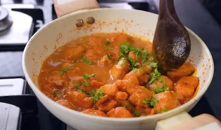 Step 7: Adding fried pakodas to moong dal curry
