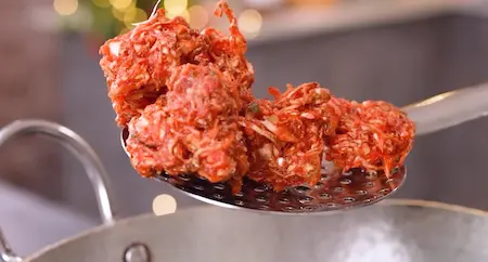 Frying cabbage fritters in oil