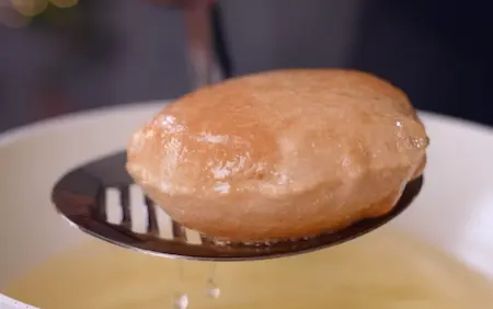 Rolling and frying pooris until golden and crispy