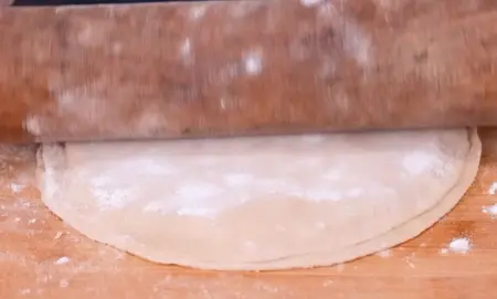 Step 4: Sealing and rolling the stuffed cheese paratha before cooking