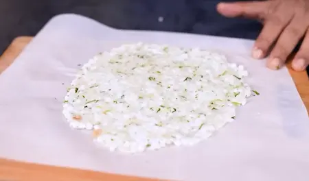 Shaping sabudana thalipeeth on parchment paper