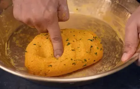 Kneading dough with kasoori methi and dalia for poori