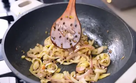 Fried onions and karela mixed with spices for Karela Pyaz Ki Sabji