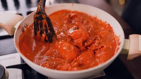Step 5: Cooking Hyderabadi Wedding Red Chicken on low flame in a kadai