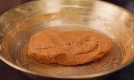 Step 3: Adding baking soda mixture to Fulwadi dough for crispy texture