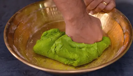 Preparing dough with methi puree for aloo methi paratha recipe