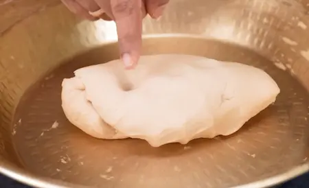 Soft whole wheat dough being kneaded and rested for making stuffed parathas