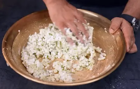 Mixing sabudana and potato dough for thalipeeth