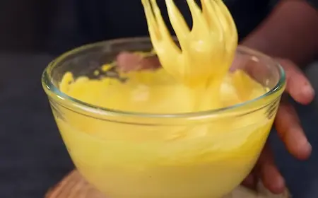 Preparing phulki batter with besan, salt, turmeric, and soda for chatpata pani phulki recipe