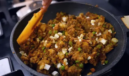Making spicy aloo paneer stuffing for samosa chaat recipe