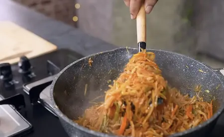 Stir frying vegetables for Chinese Pocket Samosa with high flame and sauces