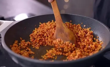 Adding spices and soaked dals to the mixture