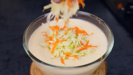 Adding grated lauki and carrot to handvo batter for healthy texture