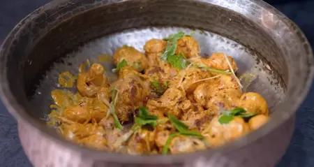 Topping mushroom base with herbs, saffron milk, and cream
