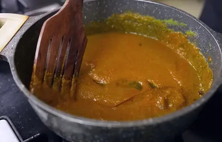 Mixing powdered spices into masala for Punjabi Dum Aloo