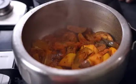 Aloo Baingan ki Sabzi in a pressure cooker with mustard oil and spices