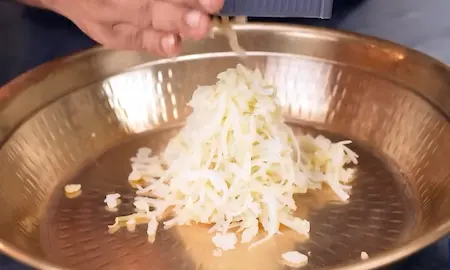 Boiled and peeled potatoes mashed in a bowl