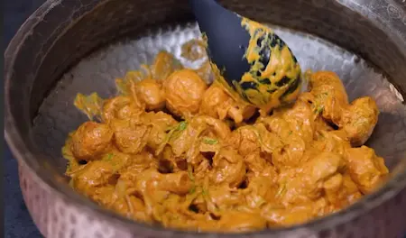 Layering marinated mushrooms in a lagan for biryani base