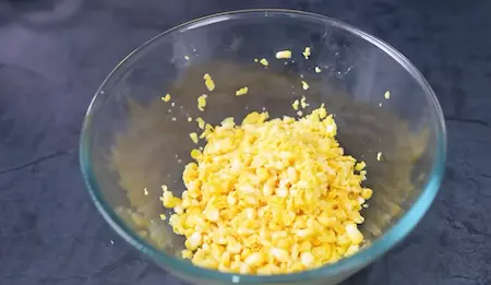 Chopping corn kernels roughly for Crispy Corn Pakoda to make a safe and crunchy mixture