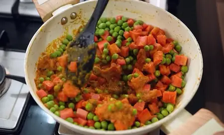 Step 7: adding carrots and peas to Gajar Matar Ki Sabji