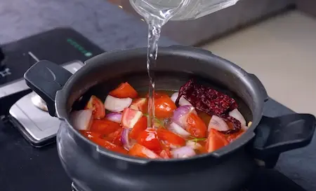 Preparing makhani gravy base with tomato, onion, and spices for palak paneer kofta sabzi