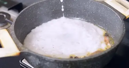 Cooking onion paste till thick and golden for Punjabi Dum Aloo