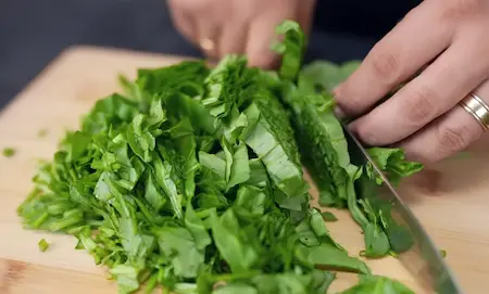 Preparing spinach for Cheesy Corn Palak Samosa Recipe by blanching and chopping palak leaves