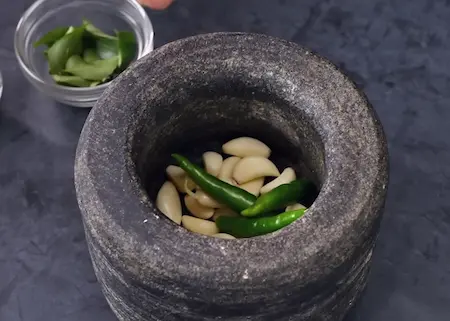 Step 1: Pounding green chillies and garlic for Kat Vada