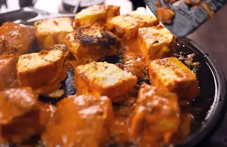 Step 3: Pan-frying marinated paneer on a hot tawa until golden brown for Paneer Changezi