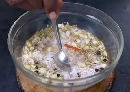 Grinding coconut, poppy seeds, cashews, and spices into a fine paste for South Indian Empty Salna