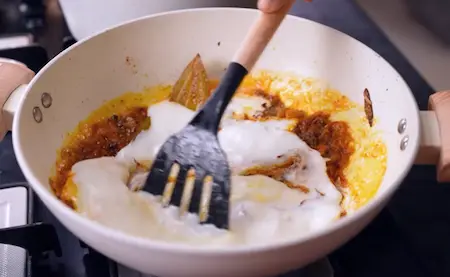 Adding ginger-garlic paste and curd to the masala.