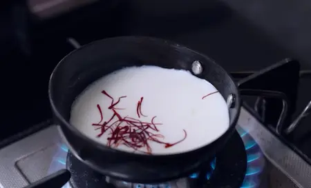 Infusing saffron in warm milk for Mushroom Biryani jhol