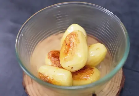 Shallow frying potatoes in mustard oil until golden brown for Punjabi Dum Aloo