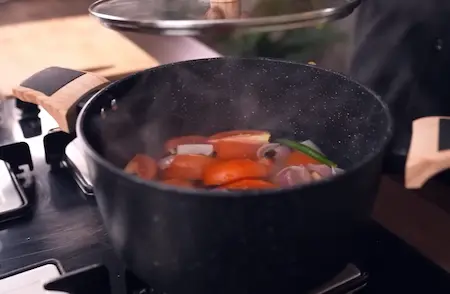 Step 1: Boiling tomatoes, onions and whole spices to prepare the gravy base for Paneer Changezi