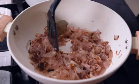 Preparing the masala base with spices and onions.